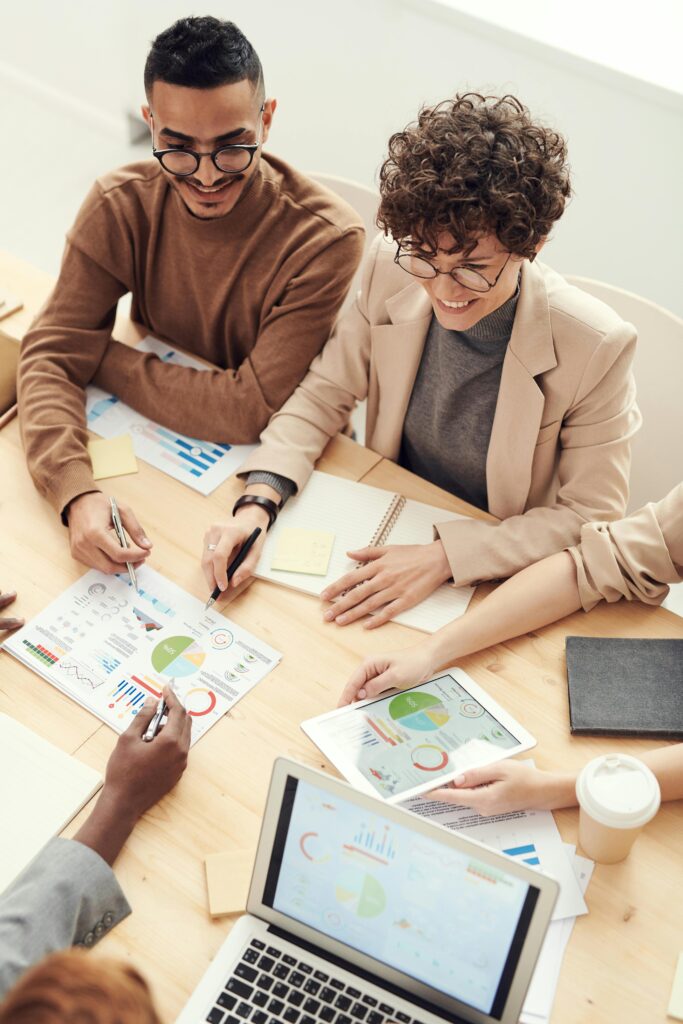 pexels-photo-3184287-3184287 A diverse team of professionals collaborating over charts and graphs during a business meeting.